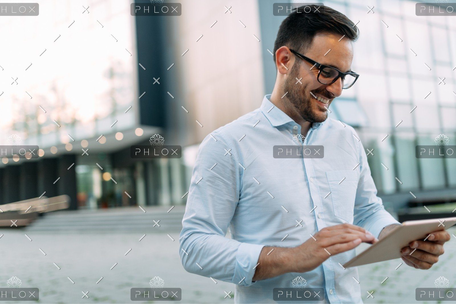 Portrait Of Businessman In Glasses Holding Tablet AWVHCJU